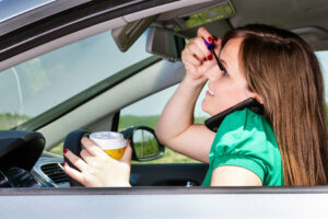 woman demonstrated three types of distracted driving by grooming, drinking coffee and using cell phone